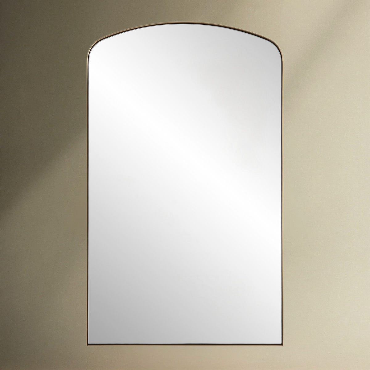 Crafted with a sleek iron frame, this arch mirror features a satin black or brass plated finish that surrounds a floating polished edge mirror.