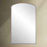Crafted with a sleek iron frame, this arch mirror features a satin black or brass plated finish that surrounds a floating polished edge mirror.
